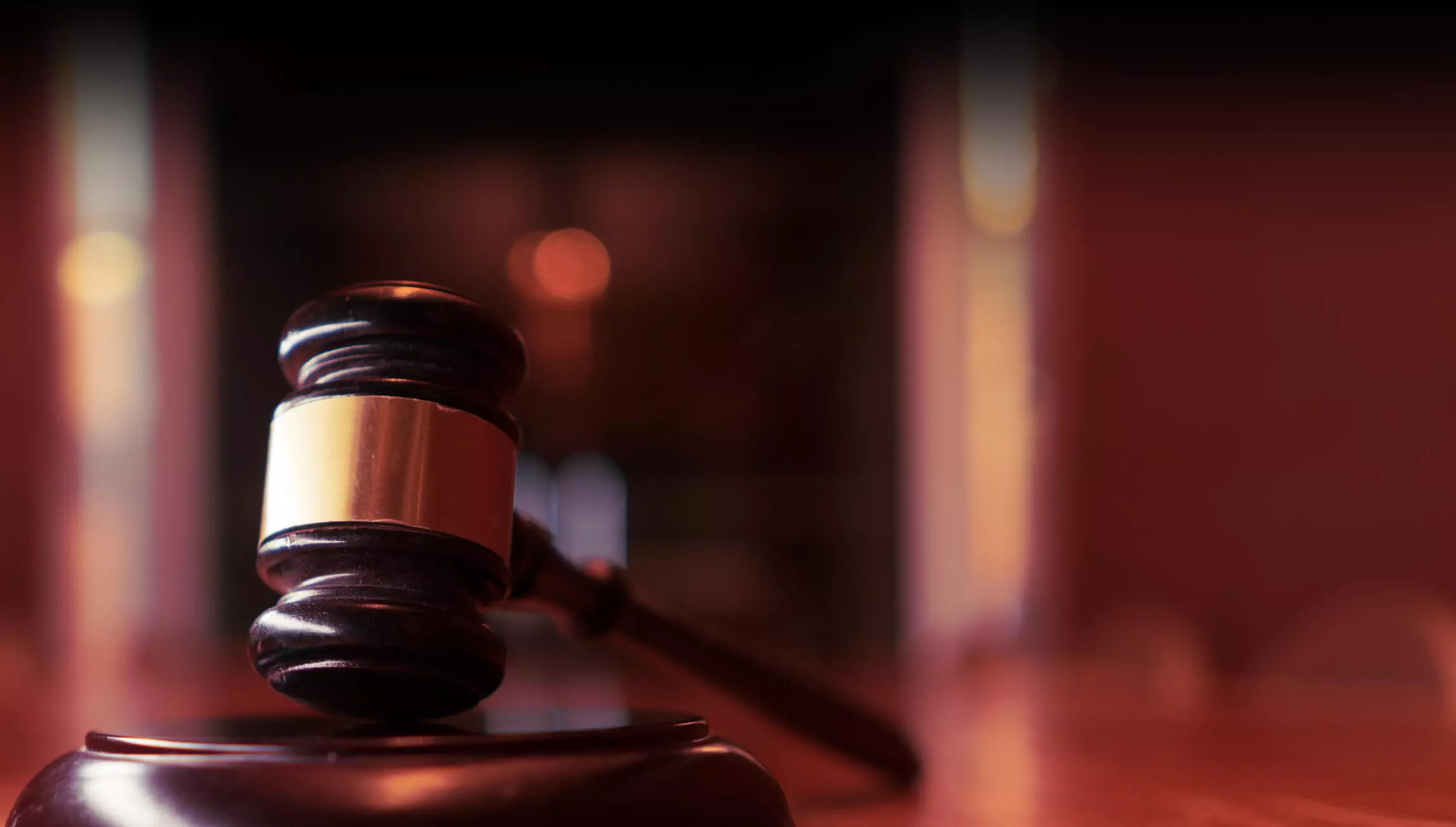 Gavel on a desk in blurry court office background